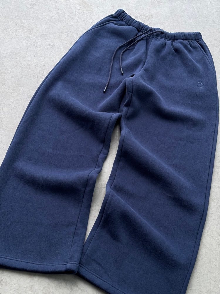 Blue sweatpants on a light gray background
