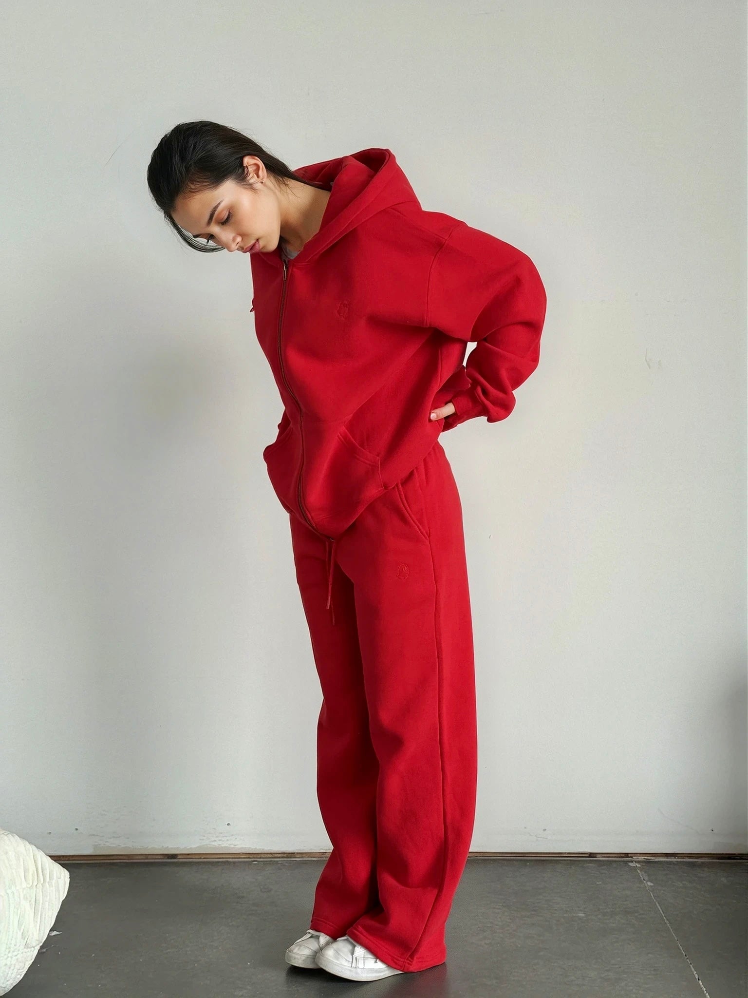 Person wearing a red outfit against a plain background