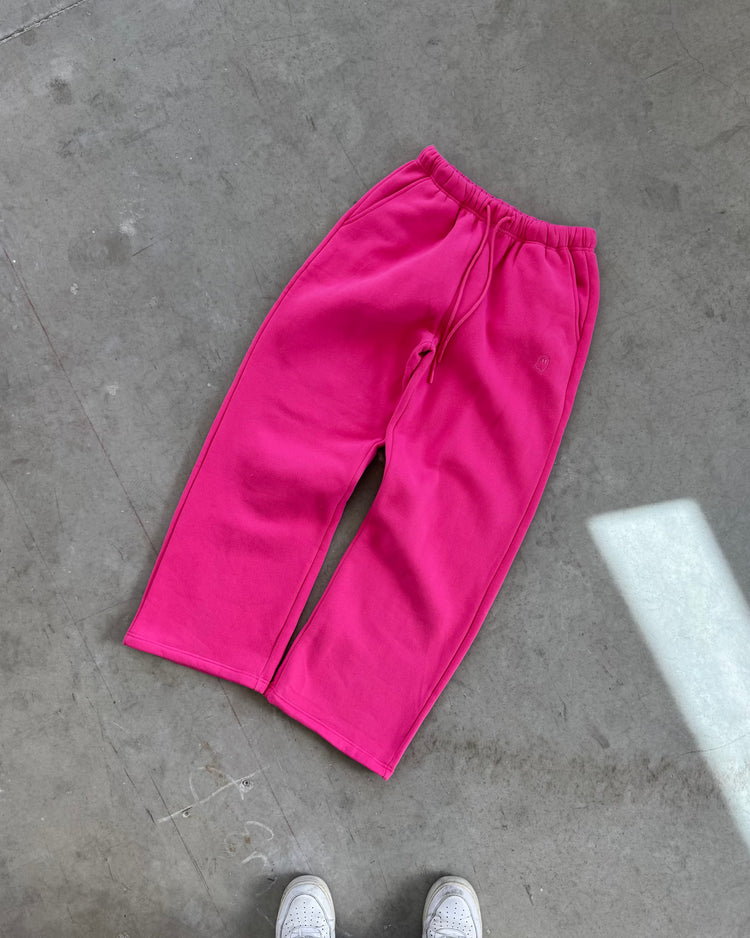 Pink pants on a gray concrete floor