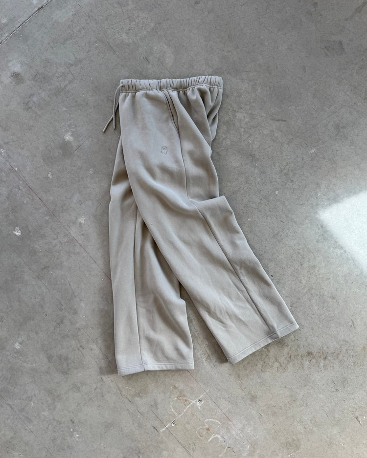 Grey pants on a gray concrete floor
