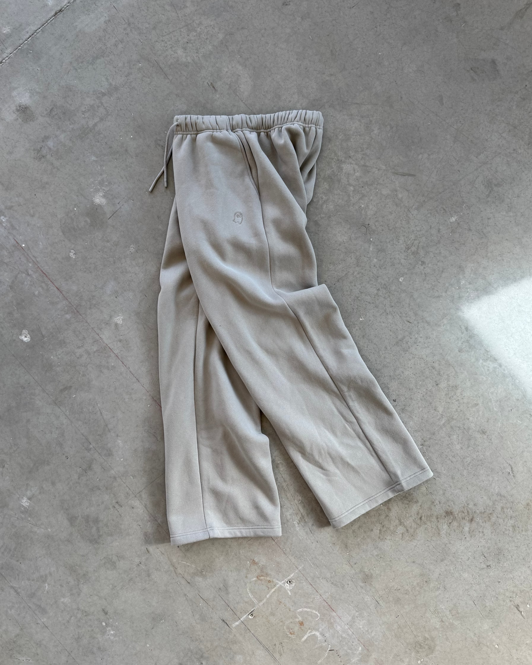 Grey pants on a gray concrete floor