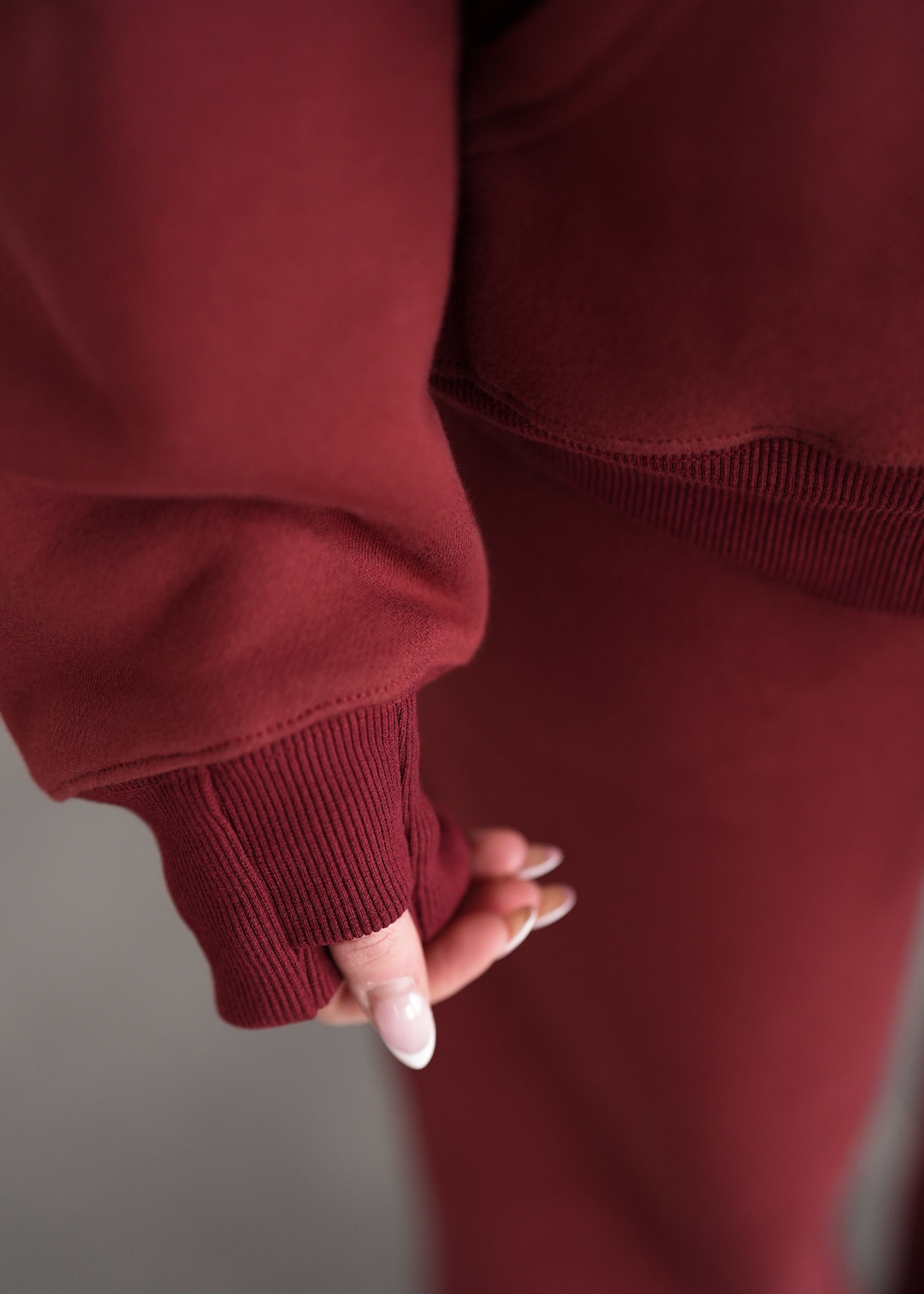 Close-up of a person wearing a maroon outfit with a blurred background