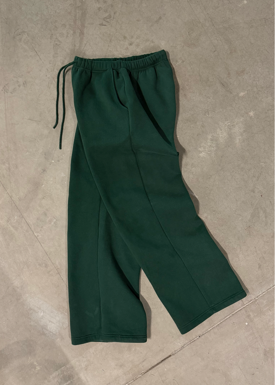 Green pants on a concrete floor