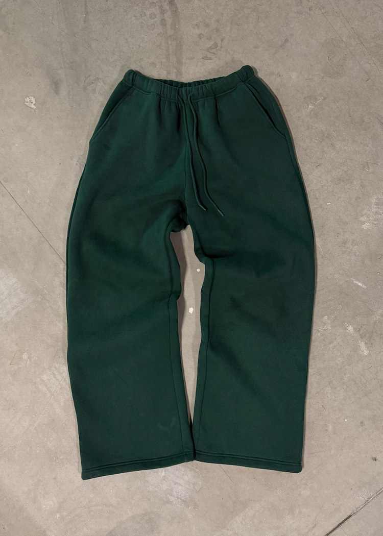 Green pants on a gray concrete floor