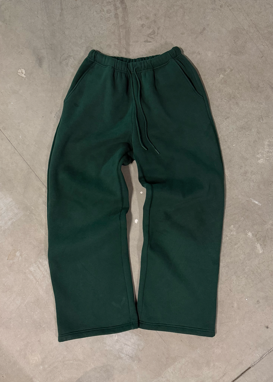 Green pants on a gray concrete floor